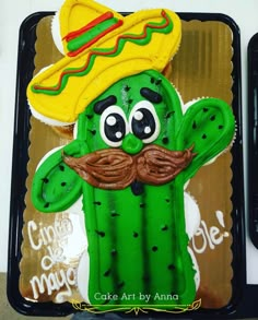 a cake shaped like a cactus wearing a sombrero