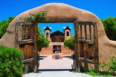 an old adobe style building with wooden doors