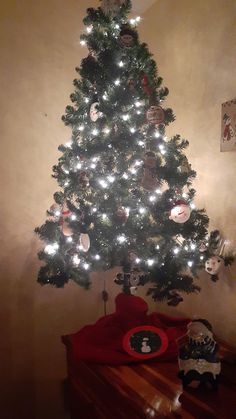 a small christmas tree is lit up with white lights