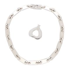 A stylish vintage Cartier 'Fidelity' chain link lock and key bracelet set in 18k white gold. The bracelet is composed of 15 individual polished white gold links which makes the bracelet a perfect contender for everyday wear. What makes this bracelet so unique is the concept and design behind it. The bracelet is fastened with a click shut fitting which require a heart shaped key to unlock and take off. Due to the style this piece would make a perfect piece of everyday jewellery. The bracelet could easily be worn by itself as a stand-alone piece, or alternatively, stacked up amongst other bracelets. The bracelet measures 17.5 centimetres in length and 0.5 centimetres in thickness (The bracelet can be shortened or lengthened upon request). There is a total weight of 19.5 grams and both key an Key Bracelet, Everyday Jewellery, Cartier Jewelry, Jewellery Uk, Lock And Key, Antique Jewellery, Everyday Jewelry, Chain Link Bracelet, Vintage Cartier