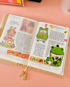 an open book with stickers on it sitting on a pink surface next to other items