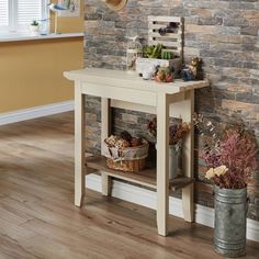 a room with a brick wall and potted plants on the shelf next to it