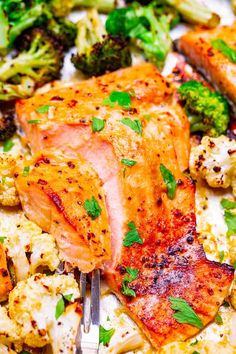 a close up of food on a plate with broccoli and cauliflower