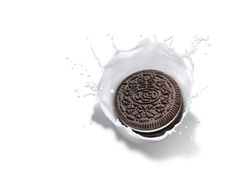 an oreo cookie in a milk splash