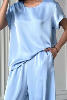 Light blue 2 piece satin loose fit set stylish and elegant!  The suit consists of a crew neck top with short sleeves and palazzo trousers with convenient pockets.  The suit will be an excellent choice for various occasions for an elegant casual look for every day, walks, as well as for special occasions for wedding guests, parties, family celebrations, receptions and more.    DETAILS - light blue  - satin  - loose fit - crew neck - short sleeve - wide leg   SIZES   This suit is available in 4 sizes S, M,  L and XL  T-shirt back length 24"/ 61 cm Shoulder 4.7"/ 12 cm  Pants inseam 29"/ 74 cm Outseam 41.33"/ 105 cm    S BUST 34 inches / 88 cm WAIST 26 inches /67 cm HIPS 37 inches / 96 cm M  BUST 36 inches / 92 cm WAIST 28 inches / 71 cm HIPS 39 inches / 100 cm L BUST 37.8"/ 96 cm WAIST 29.5" Satin Pant Suit Women, Elegant Solid Color Short Sleeve Sets, Elegant Short Sleeve Sets, Elegant Short Sleeve Satin Set, Blue Satin Sets For Summer, Elegant Silk Short Sleeve Sets, Summer Silk Sets With Short Sleeves, Pantsuit Wedding Guest, Satin Pantsuit