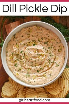 a white bowl filled with dill pickle dip surrounded by crackers