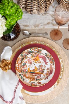 a place setting with plates, napkins and flowers