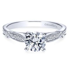 a white gold engagement ring with diamonds on the side