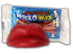 a close up of a bag of wax on top of a red lip and tongue