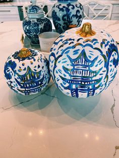 two blue and white vases sitting on top of a table