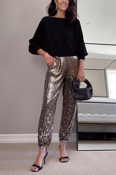 Show off your style in these sparkling Glam High Rise Sequin Joggers. With a contemporary design made of shimmering sequin fabric, these joggers offer perfect comfort and shimmering flair. Make a statement and add glam to your wardrobe. Material:Cotton+Polyester+Sequin SIZE US/CAN BUST WAIST HIPS S 2-4 33"-34" 26"-27" 36"-37" M 6-8 35"-36" 28"-29" 38"-39" L 10-12 37"-39" 30"-32" 40"-42" XL 12-14 40"-42" 33"-35" 43"-45" Glamorous Metallic Sequin Pants, Chic Metallic Winter Bottoms, Glitter Bottoms For Night Out In Winter, Metallic Bottoms With Contrast Sequin For Party Season, Metallic Sequined Pants For Party Season, Glitter Bottoms For Winter Night Out, Glamorous Sequined Bottoms For Winter, Stretch Metallic Pants With Sequins, Metallic Stretch Pants With Sequins