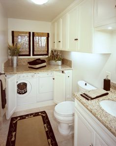 a washer and dryer in a bathroom with granite counter tops on the floor