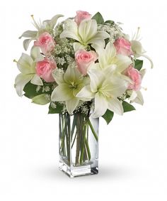 a vase filled with white and pink flowers