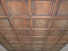 the ceiling in this room is made out of wood and has square tiles on it