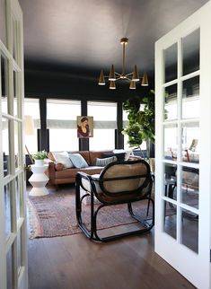 a living room filled with furniture and lots of windows