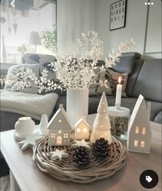 a table topped with white christmas decorations and candles