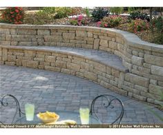 an outdoor patio with stone steps and seating area