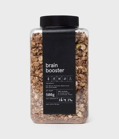 a jar filled with granola next to a black label that says brain booster on it