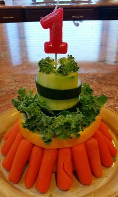 a cake made to look like carrots, cucumber and lettuce