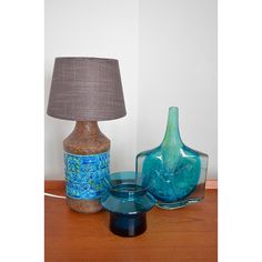 a table with two vases and a lamp on it