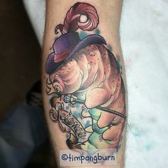 a man with a fish tattoo on his arm holding a fishing rod and wearing a hat