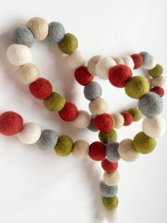 several different colored balls on a white surface with one bead in the shape of an x