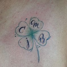 a four leaf clover tattoo with the letter c on it's chest and initials below