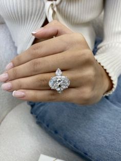 a woman's hand with a diamond ring on it