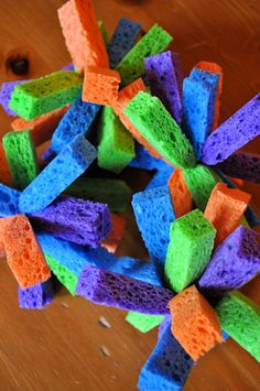 there is a pile of multicolored sponges on the floor