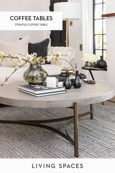 a living room filled with furniture and flowers on top of a coffee table in front of a fire place