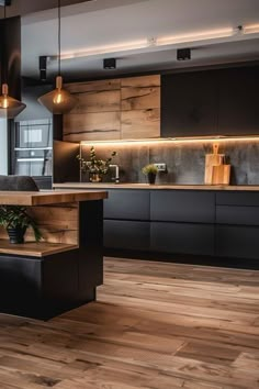 a kitchen with wooden flooring and black cabinetry next to a counter top oven