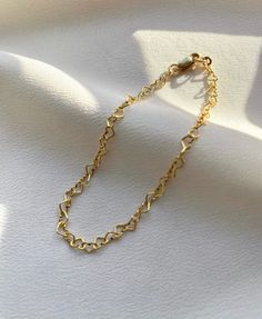 Delicate 14kt gold filled heart chain bracelet. The delicate and minimalist design of this link bracelet goes well with both casual and sophisticated looks. Wear it on its own or layered with other bracelets in our shop. Perfect for a gift! ✦ MATERIALS ✦ 14kt gold filled heart chain and lobster claw clasp. ✦ SIZING ✦ Available in 3mm width. ✦ PACKAGING ✦ All orders are packed in jewelry boxes/pouches with a brand logo, which makes it perfect for gifting. All packaging materials including mailers Heart Link Bracelet, Trendy Gold Heart Bracelet With Adjustable Chain, Trendy Gold Heart Bracelet With Chain, Everyday Gold Double Heart Bracelet, Delicate Heart Bracelet For Valentine's Day, Minimalist Charm Bracelet With Gold Chain As A Gift, Minimalist Charm Bracelet With Gold Chain For Gift, Dainty Heart Bracelets For Everyday, Delicate Gold Bracelets For Valentine's Day