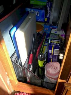 the drawer is full of office supplies and items