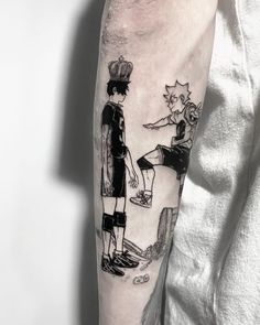 a man with a tattoo on his arm has a drawing of two people standing next to each other