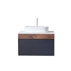 a white sink sitting on top of a wooden counter next to a black and brown cabinet