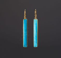 This pair of long turquoise earrings would be great reward for your self or a great gift for your mother or best friend. The pendant has a turquoise stone set in gold plated bezels: 1. Stone :turquoise (reconstituted and stabilized) 2. Stone size: 40 x 7 mm 3. earring total length ~ 58 mm 4. bezel material: gold vermeil or sterling silver 5. earring hook: gold vermeil or sterling silver 6. an optional custom jewelry card printed with your own message, if you are sending these as a gift. Earrings Real Turquoise Earrings, Long Turquoise Earrings, Turquoise Bar, Earring Long, December Birthday Gifts, Turquoise Earring, Engraved Locket, Real Nature, Natural Turquoise Stone