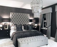 a bedroom with a large bed and chandelier