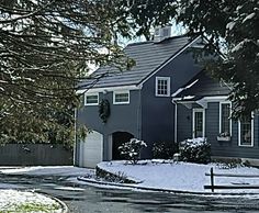 a house with snow on the ground and trees