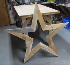 a wooden star sitting on top of a table in a room filled with other items