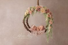 a newborn baby in a flower hoop