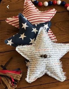 several patriotic stars and tassels on a wooden table with beaded beads around them