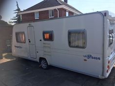 an rv parked in front of a house