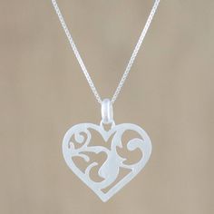 A sleek heart encloses a jungle of tangled vines and curvaceous leaves in this necklace from Sarote Lochotinunt of Thailand. The artisan crafts the pendant from sterling silver with a brushed satin finish and centers it on a sterling Venetian box chain. The necklace makes a subtly romantic statement to wear anywhere. Nature-inspired Silver Heart Necklace, Valentine's Day Pendant Necklace With Intricate Design, Sterling Silver Heart Pendant Necklace With Intricate Design, Valentine's Day Sterling Silver Filigree Necklace, Sterling Silver Necklace Pendants, Artisan Craft, Silver Pendant Necklace, Ladies Tops Fashion, Heart Pendant Necklace