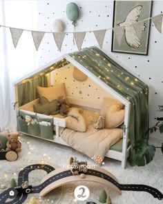 a child's room with a bed and toy train tracks on the floor in front of it