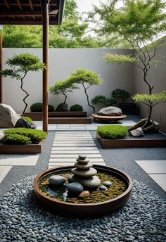 a small garden with rocks and trees in the center, surrounded by graveled walkways