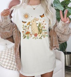 RETRO BUNNY MUSHROOMS Cottagecore T-shirt, Cute Vintage Rabbit Boho Garden Shirt, Magic Mushroom Happy Hippie T-shirt, Botanical Floral Tee, Nature Lover Gift, Plant Mama Shirt, Fairycore Shirt, Positive Happy Vibes Don't blame yourself for being so pretty! This Cute Retro Bunny Cottagecore shirt is everything you've dreamed of and more. It feels soft and warm, with the right amount of stretch. It's comfortable and flattering for all.  This Vintage Rabbit Boho Garden T-shirt makes a perfect choi Bunny Cottagecore, Mushrooms Cottagecore, Fairycore Shirt, Garden Shirt, Plant Mama, Cottagecore Shirt, Hippie T Shirts, Boho Garden, Happy Hippie