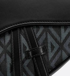 The Saddle bag presents a new take on a Dior classic with a variation inspired by House archives. Made in black coated cotton canvas with the CD Diamond printed motif, it showcases Marc Bohan's 1974 graphic design reimagining the CD initials in the form of a diamond with architectural lines, and is adorned with tonal smooth calfskin. The style has a tonal smooth calfskin magnetic flap concealing a zip pocket that safely stores the essentials. The adjustable Christian Dior jacquard strap allows t Designer Black Coated Canvas Bags, Designer Black Shoulder Bag With Leather Lining, Black Shoulder Bag With Leather Lining And Coated Canvas, Designer Black Bags With Leather Lining, Marc Bohan, Dior Star, Icon Shoes, Dior Book Tote, Diamond Print