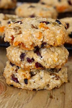 three oatmeal cookies stacked on top of each other with dried cranberries