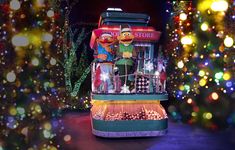 the sesame street christmas tree is decorated with lights