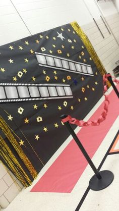 this is an image of a school hallway decorated in gold and black with stars on it